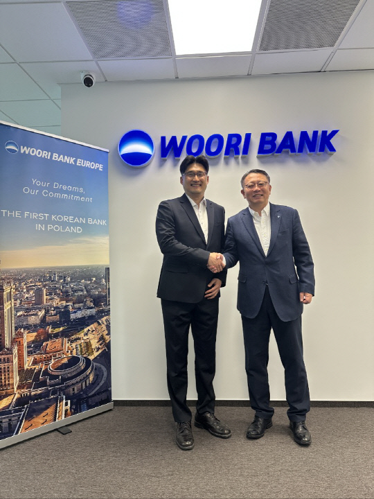 정진완(오른쪽) 우리은행장이 지난 7일 폴란드지점에서 한국수자원공사 안정환 UKR재건추진단장과 미팅을 가진 뒤 악수를 나누고 있다. [우리은행 제공]